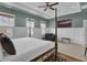Spacious bedroom with a four-poster bed, ample natural light, and stylish decor at 1821 Mead Ln, Johns Island, SC 29455