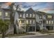 Charming two-story coastal home with a covered porch, white railings, and a convenient ground-level garage at 1821 Mead Ln, Johns Island, SC 29455