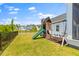 Well-maintained backyard featuring a swing set and slide, perfect for Gathering fun at 1828 Agate Bay Dr, Mount Pleasant, SC 29466
