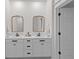 Modern bathroom with double vanity, framed mirrors, and sleek fixtures. The decor is clean and simple at 1828 Agate Bay Dr, Mount Pleasant, SC 29466