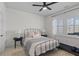 Inviting bedroom with a black metal bed frame and soft, neutral decor and a window with shutters at 1828 Agate Bay Dr, Mount Pleasant, SC 29466