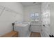 Clean laundry room with modern appliances, natural light, and woven storage basket at 1828 Agate Bay Dr, Mount Pleasant, SC 29466