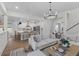 Open-concept living room with a kitchen, large sectional couch, and stairs leading to the second floor at 1828 Agate Bay Dr, Mount Pleasant, SC 29466