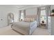 Comfortable bedroom with a large upholstered bed, soft lighting, and a neutral color palette at 1828 Agate Bay Dr, Mount Pleasant, SC 29466