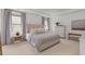 Comfortable bedroom with a large upholstered bed, soft lighting, and a neutral color palette at 1828 Agate Bay Dr, Mount Pleasant, SC 29466