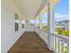 Inviting covered porch with wood floors, white columns, and views of the neighborhood at 1828 Agate Bay Dr, Mount Pleasant, SC 29466