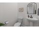 Clean powder room featuring a pedestal sink, toilet, and decorations at 1828 Agate Bay Dr, Mount Pleasant, SC 29466