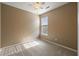 This bedroom features neutral carpeting, a ceiling fan and a sun-filled window at 183 Cypress Forest Dr, Moncks Corner, SC 29461