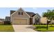 Charming single-Gathering home showcasing a manicured lawn, a driveway, and a two-car garage at 183 Cypress Forest Dr, Moncks Corner, SC 29461