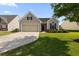 Charming single-Gathering home showcasing a manicured lawn, a driveway, and a two-car garage at 183 Cypress Forest Dr, Moncks Corner, SC 29461