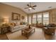 Cozy living room boasts a high ceiling, neutral paint, a ceiling fan, and ample natural light at 183 Cypress Forest Dr, Moncks Corner, SC 29461