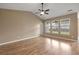Spacious main bedroom featuring wood floors, high ceilings, and three large windows at 183 Cypress Forest Dr, Moncks Corner, SC 29461