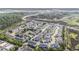 Aerial view of a neighborhood featuring modern townhomes, a community pond and pool at 185 Winding River Dr, Johns Island, SC 29455