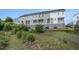 Rear view of property showing deck/balcony areas and community lawn at 185 Winding River Dr, Johns Island, SC 29455
