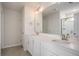 Well-lit bathroom featuring double vanity, granite countertops, chrome fixtures, and a large mirror at 185 Winding River Dr, Johns Island, SC 29455