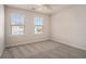Bright bedroom with neutral carpet, two windows with view, and plenty of space at 185 Winding River Dr, Johns Island, SC 29455