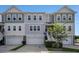 Charming gray townhome with well-maintained lawn and attached garage at 185 Winding River Dr, Johns Island, SC 29455