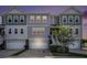 Charming gray townhome with well-maintained lawn and attached garage at dusk at 185 Winding River Dr, Johns Island, SC 29455
