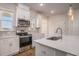Stylish kitchen with white cabinets, stainless appliances, granite countertops, and hanging pendant lights at 185 Winding River Dr, Johns Island, SC 29455