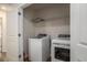 Convenient laundry area with a washer, dryer, and overhead storage shelves at 185 Winding River Dr, Johns Island, SC 29455
