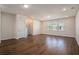 Bright, empty living room with wood-look flooring and natural light from many windows at 185 Winding River Dr, Johns Island, SC 29455