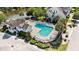 Community pool area with pool house, lounge chairs, and lush tropical landscaping at 185 Winding River Dr, Johns Island, SC 29455