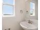 Cozy powder room features a pedestal sink, chrome fixtures, and a window for natural light at 185 Winding River Dr, Johns Island, SC 29455