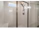 Updated shower features white subway tile, glass doors, rain shower head, and a built-in bench at 185 Winding River Dr, Johns Island, SC 29455