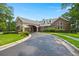 Clubhouse exterior with covered drive, brick facade, dormer windows, and beautifully landscaped lawn at 207 Brutus Ln, Summerville, SC 29485