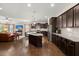 Spacious kitchen with island, dark cabinets, stainless appliances, and open to the living area at 207 Brutus Ln, Summerville, SC 29485