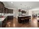 Open-concept kitchen with island seating, stainless steel appliances, and dark wood cabinetry at 207 Brutus Ln, Summerville, SC 29485