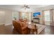 Cozy living room with leather furniture, large windows, and hardwood floors at 207 Brutus Ln, Summerville, SC 29485