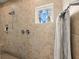 Shower with tan tile surround and a rain shower head, plus a window at 207 Brutus Ln, Summerville, SC 29485