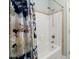 Shower with a floral curtain, white tub and surround, and a shower head on a slider bar at 207 Brutus Ln, Summerville, SC 29485