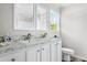 Bathroom with dual sinks, marble countertops, and a window for natural light at 208 General Moultrie Dr, Bonneau, SC 29431