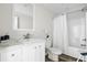 Bathroom with marble countertop, decorative mirror, and shower with a white curtain at 208 General Moultrie Dr, Bonneau, SC 29431