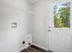 Bright laundry room featuring water hookups, access to the backyard and wire shelving at 208 General Moultrie Dr, Bonneau, SC 29431