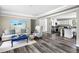 Open-concept living room flowing into kitchen, featuring stylish decor and wood flooring at 208 General Moultrie Dr, Bonneau, SC 29431