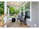 Charming front porch featuring a bench and decorative pillows at 208 General Moultrie Dr, Bonneau, SC 29431