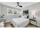 Comfortable bedroom features a ceiling fan, a window with lots of natural light, and wood flooring at 209 Pineview Dr, Goose Creek, SC 29445