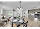 Cozy dining area with table set for four, seamlessly connecting to the living room and kitchen at 209 Pineview Dr, Goose Creek, SC 29445