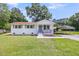 Beautifully maintained white brick home with a carport on a lush green lawn under a sunny sky at 209 Pineview Dr, Goose Creek, SC 29445