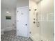 Bathroom features patterned tile flooring, white walls, and walk-in shower at 21 George St # 102, Charleston, SC 29401