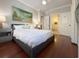 Bedroom features a painting, gray walls, and doorway to the bathroom at 21 George St # 102, Charleston, SC 29401