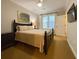 Bedroom with dark furniture, carpet, and a mounted television at 21 George St # 102, Charleston, SC 29401