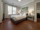 Bedroom features a large window, hardwood floors, and ceiling fan at 21 George St # 102, Charleston, SC 29401