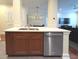 Kitchen island with stainless steel appliances and brown cabinets at 21 George St # 102, Charleston, SC 29401