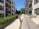Relaxing outdoor patio space with table, chairs, grill, and greenery for a perfect outdoor getaway at 21 George St # 102, Charleston, SC 29401
