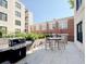 This beautiful patio features a grill, table, chairs, and garden to provide a private outdoor living experience at 21 George St # 102, Charleston, SC 29401