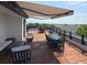 Spacious rooftop deck featuring wood tile flooring, comfortable seating, and a retractable awning at 21 George St # 102, Charleston, SC 29401